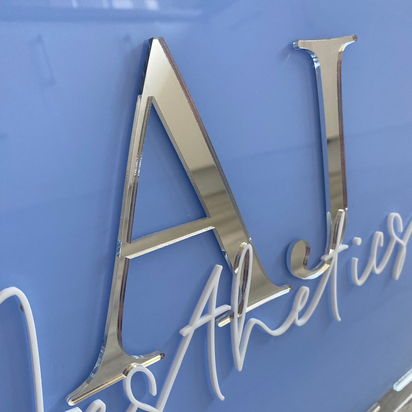 Close up photo showing the 3d detail of the acrylic business logo sign