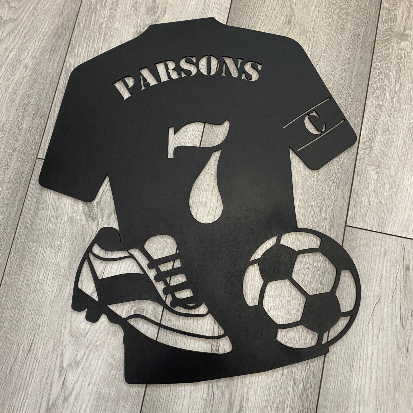 Custom Bedroom Wall art in the shape of a football shirt with cut out ball and boots.
