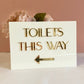 A5 Directional Sign made in white gloss acrylic and 3d gold mirror text.