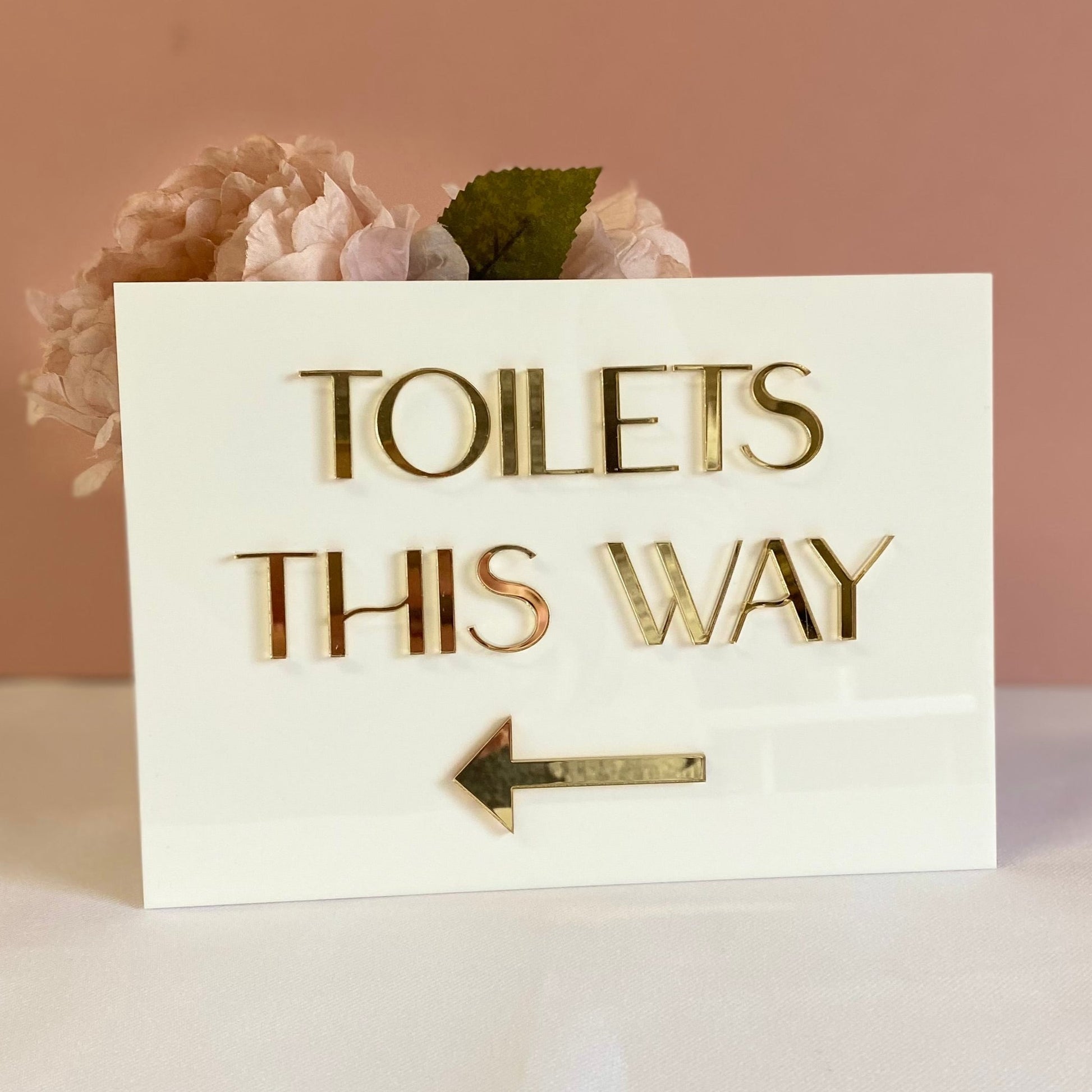 A5 Directional Sign made in white gloss acrylic and 3d gold mirror text.