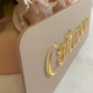 Side view showing 3d detail of the business door sign with nude acrylic background and gold mirror business name