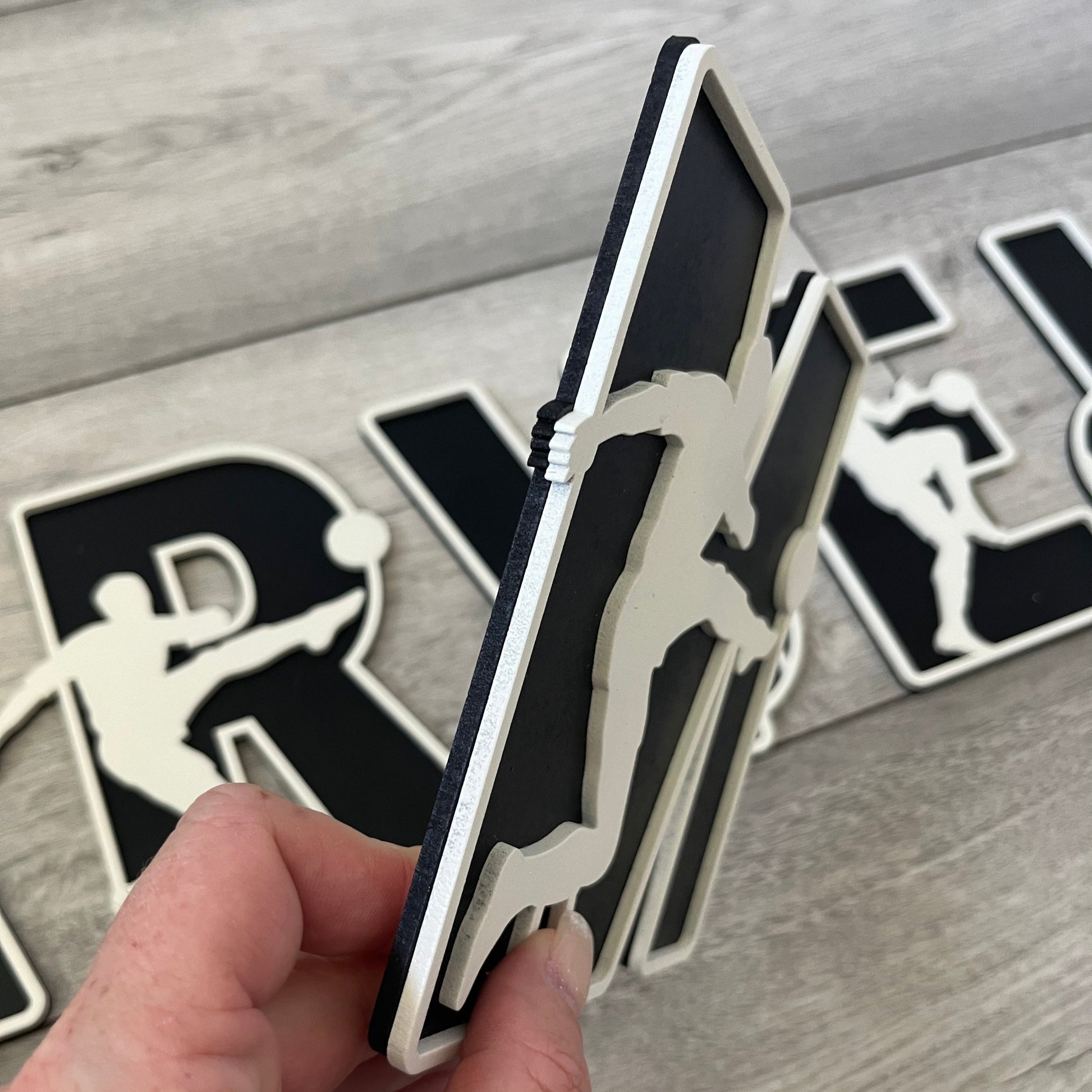 Side view of wooden football letter